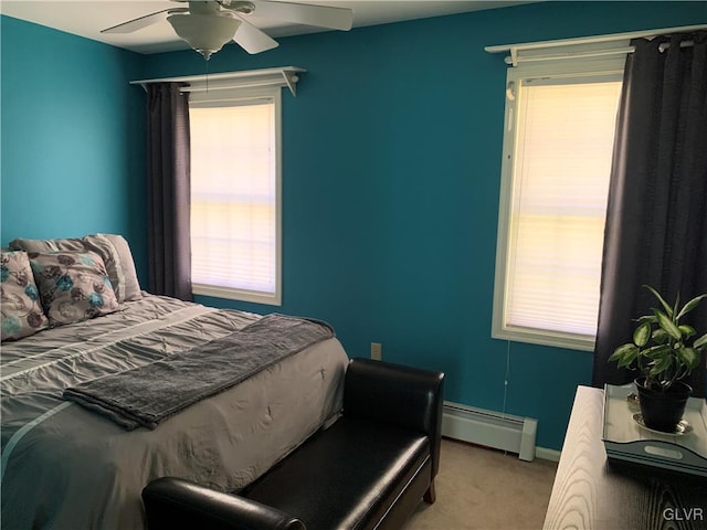 bedroom featuring a baseboard radiator, light carpet, and ceiling fan