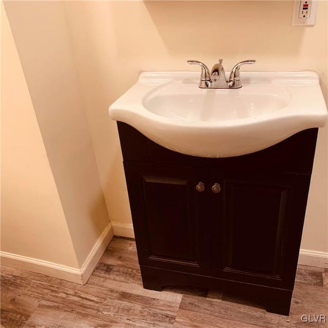 bathroom with vanity and hardwood / wood-style flooring