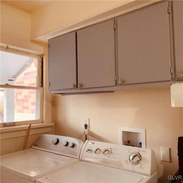 laundry area featuring cabinets and washing machine and dryer