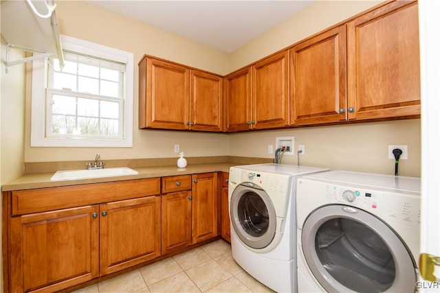 laundry area with cabinets, separate washer and dryer, light tile patterned flooring, and sink