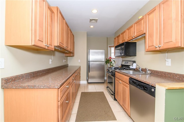 kitchen with light tile patterned floors, sink, and appliances with stainless steel finishes