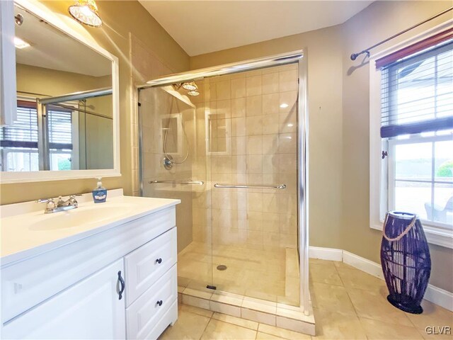 bathroom featuring tile patterned floors, vanity, and walk in shower