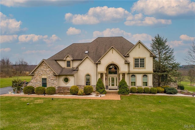 french provincial home with french doors and a front lawn