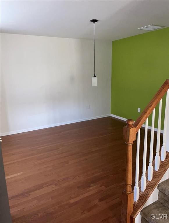 empty room featuring dark wood-type flooring