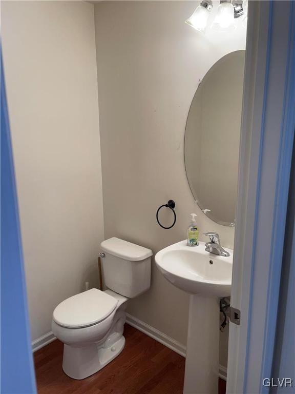 bathroom featuring hardwood / wood-style flooring and toilet