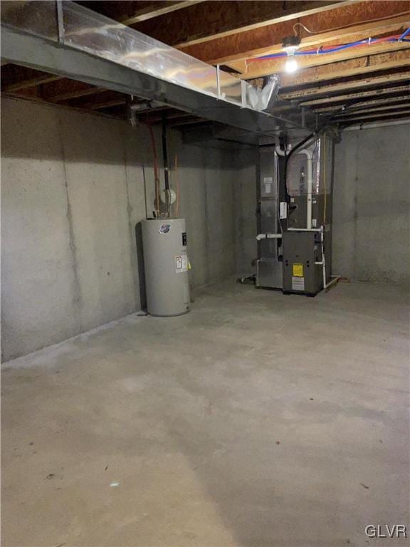 basement featuring water heater and heating unit