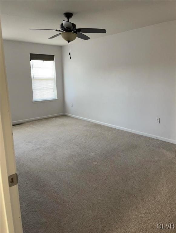 empty room with ceiling fan and carpet floors