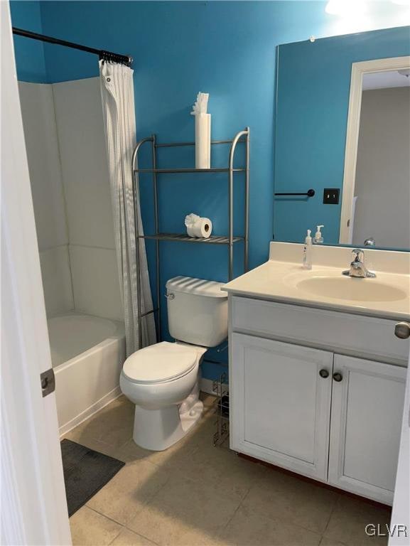 full bathroom with vanity, toilet, tile patterned floors, and shower / bath combination with curtain