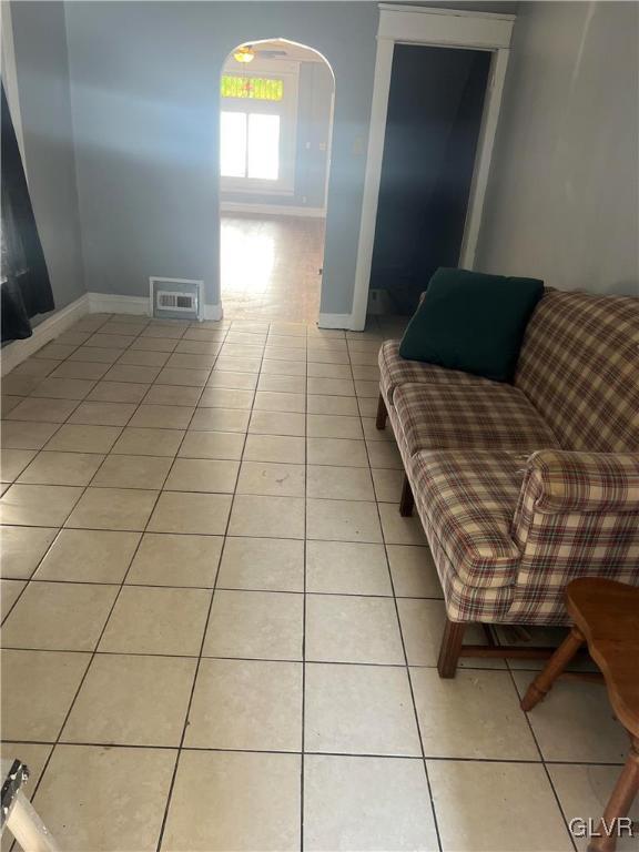 unfurnished living room featuring light tile patterned floors