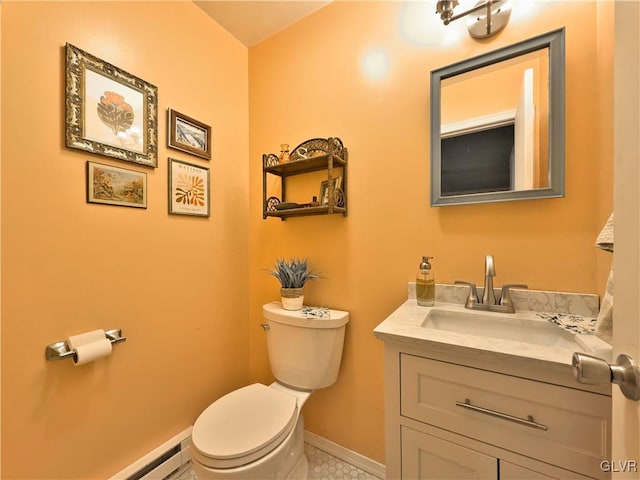 bathroom featuring toilet, baseboard heating, vanity, and tile patterned flooring