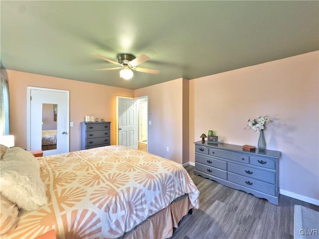 bedroom featuring ceiling fan and dark hardwood / wood-style flooring