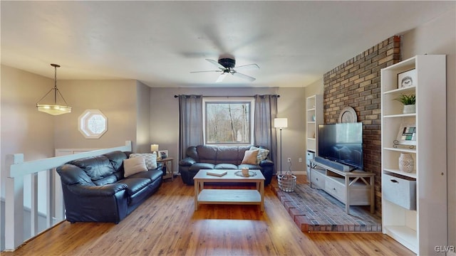 living room featuring a wealth of natural light, light hardwood / wood-style flooring, and ceiling fan