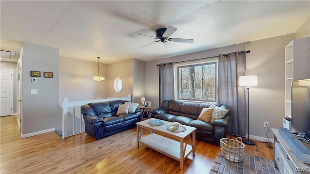 living room with ceiling fan and light wood-type flooring