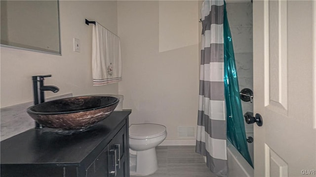 full bathroom featuring vanity, toilet, and shower / bath combination with curtain