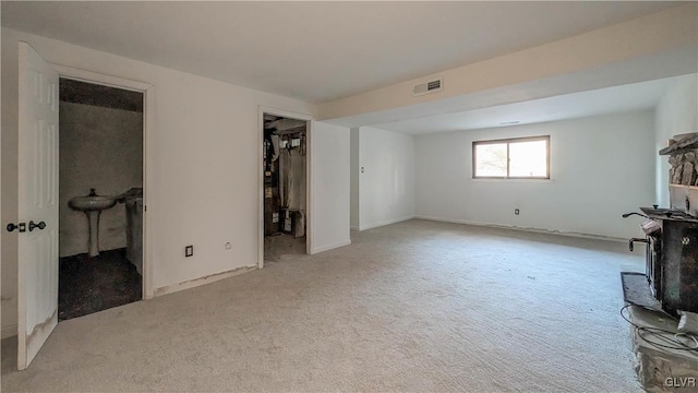 unfurnished living room with light colored carpet