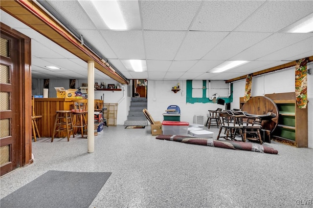 interior space featuring a drop ceiling and bar area