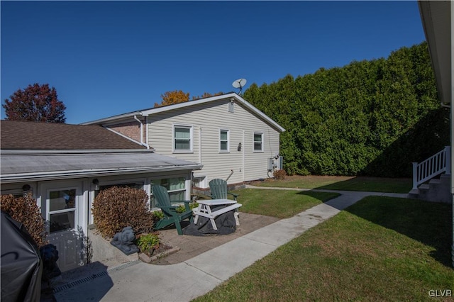 rear view of house with a patio area and a lawn