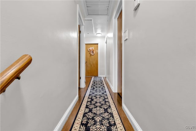 hallway with hardwood / wood-style floors