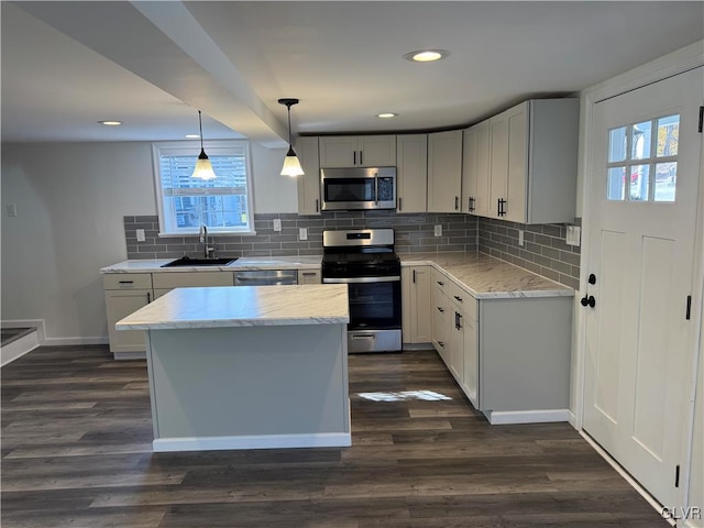 kitchen with a healthy amount of sunlight, stainless steel appliances, dark wood-type flooring, and sink