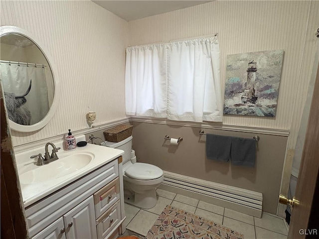 bathroom with toilet, vanity, tile patterned floors, and a baseboard heating unit