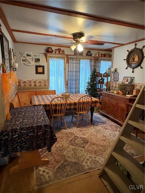 dining space with ceiling fan and a textured ceiling