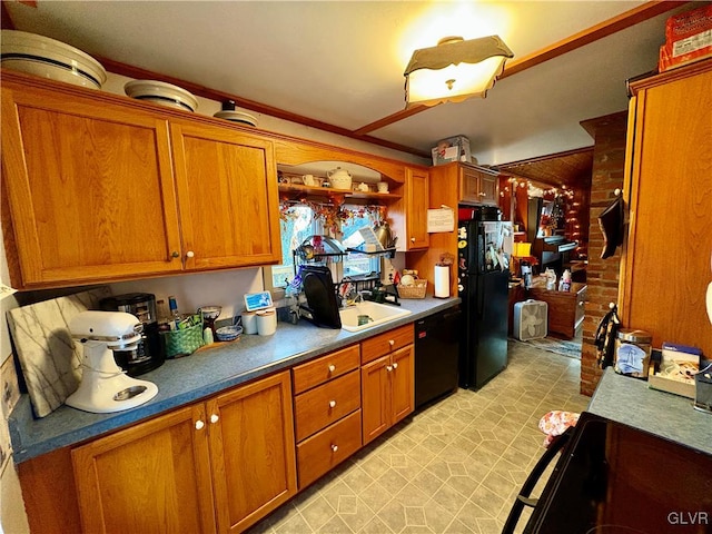 kitchen featuring black appliances, sink, and wooden walls