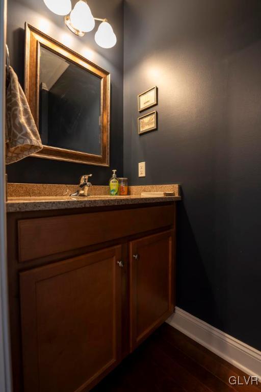 bathroom with hardwood / wood-style floors and vanity