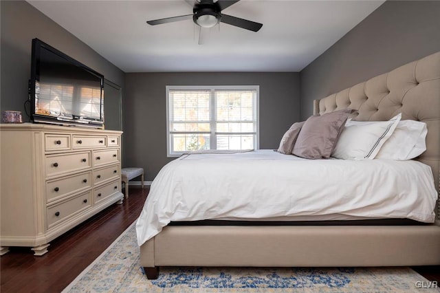 bedroom with dark hardwood / wood-style floors and ceiling fan