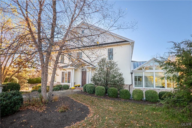 greek revival house featuring a sunroom