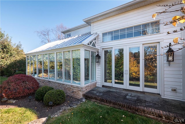 back of property with french doors and a sunroom