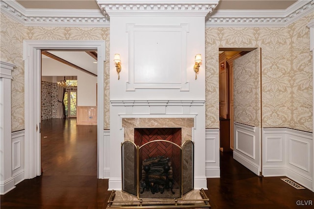 interior space featuring ornamental molding, a high end fireplace, and dark hardwood / wood-style flooring