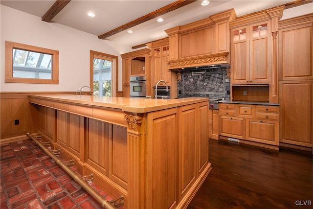 kitchen with oven, sink, a skylight, butcher block counters, and dark hardwood / wood-style floors