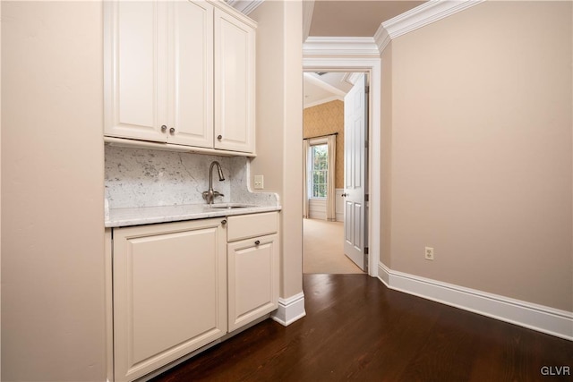 bar featuring white cabinets, ornamental molding, sink, and dark hardwood / wood-style flooring