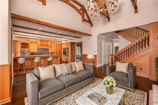 living room with beam ceiling, a towering ceiling, and dark hardwood / wood-style floors