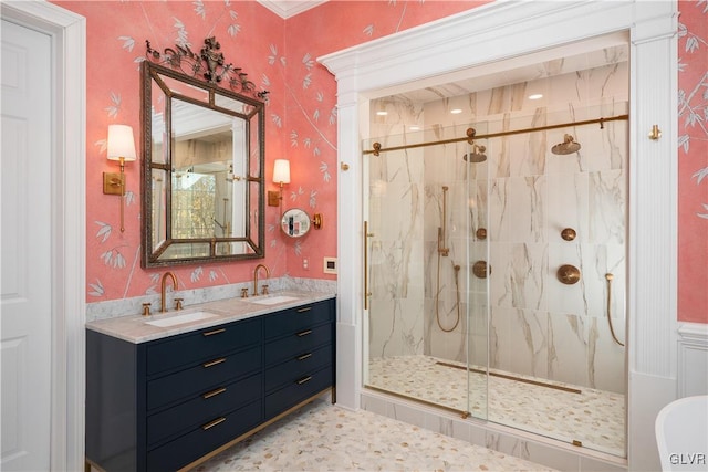 bathroom featuring vanity, ornamental molding, and a shower with door