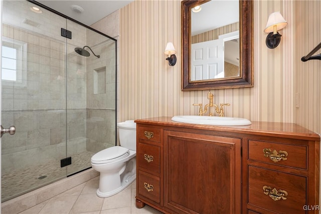 bathroom with toilet, walk in shower, vanity, and tile patterned floors