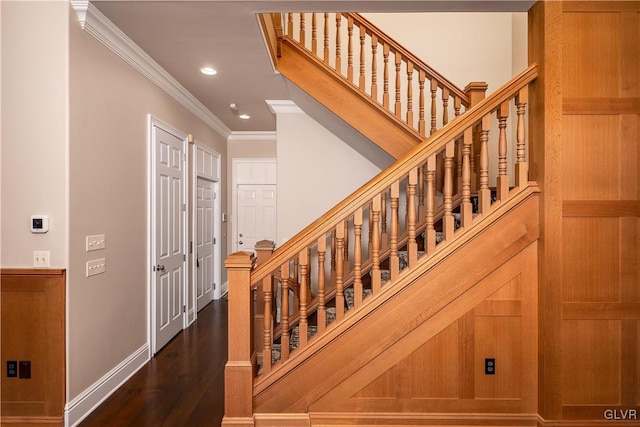 stairs with crown molding and hardwood / wood-style flooring