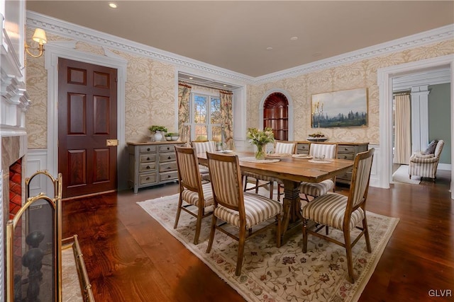 dining space with dark wood-type flooring and ornamental molding