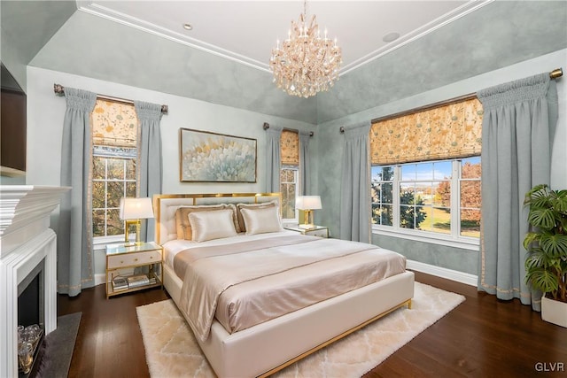 bedroom with crown molding, a notable chandelier, dark hardwood / wood-style floors, and a tray ceiling