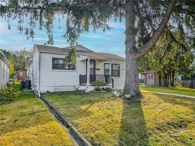 bungalow-style home with central AC and a front lawn