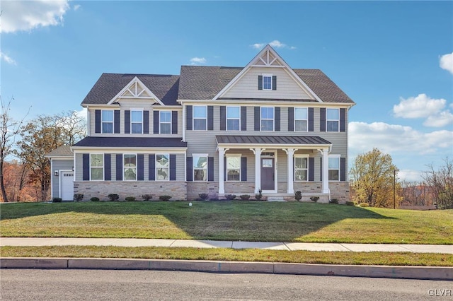 view of front of house with a front yard and covered porch