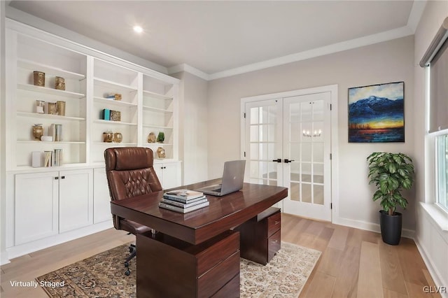 home office with ornamental molding, french doors, and light hardwood / wood-style floors