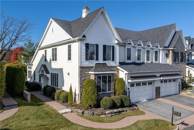 view of front of property featuring a front lawn and a garage