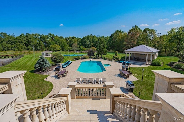 view of swimming pool featuring a patio area and a lawn