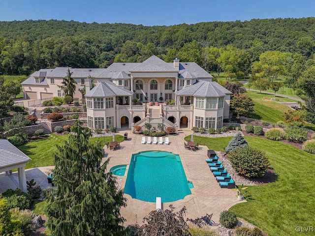 rear view of property featuring a patio area and a balcony