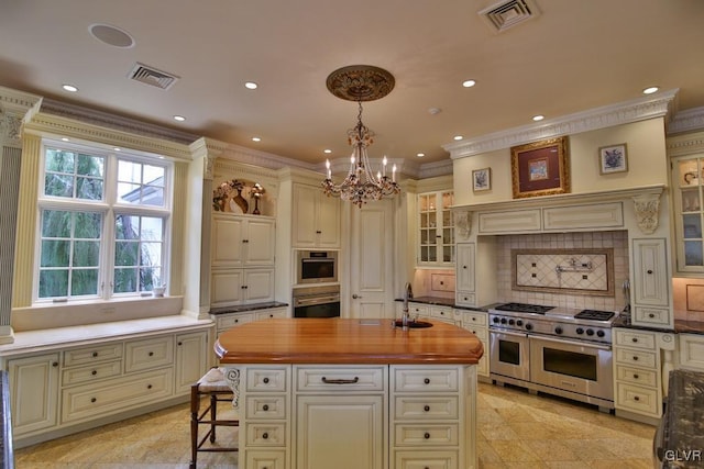 kitchen with tasteful backsplash, appliances with stainless steel finishes, pendant lighting, a kitchen island, and ornamental molding