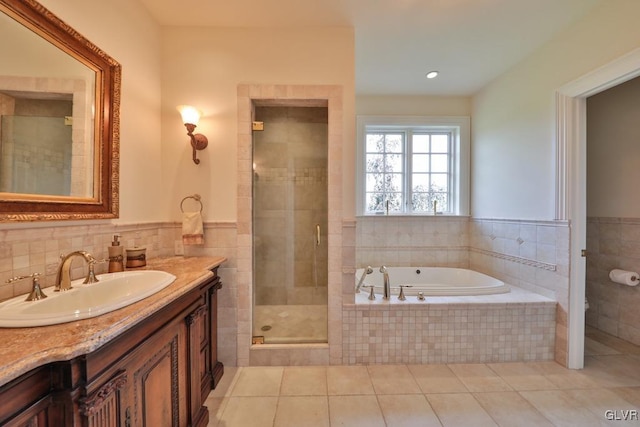 bathroom featuring tile patterned floors, vanity, and separate shower and tub