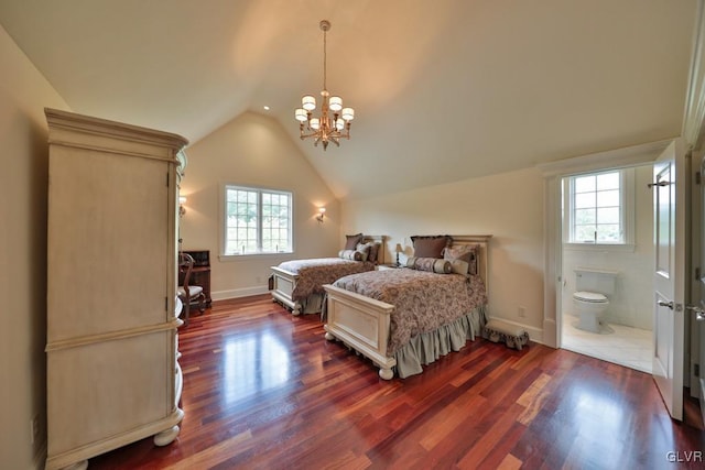 bedroom featuring lofted ceiling, ensuite bathroom, dark wood-type flooring, and a notable chandelier