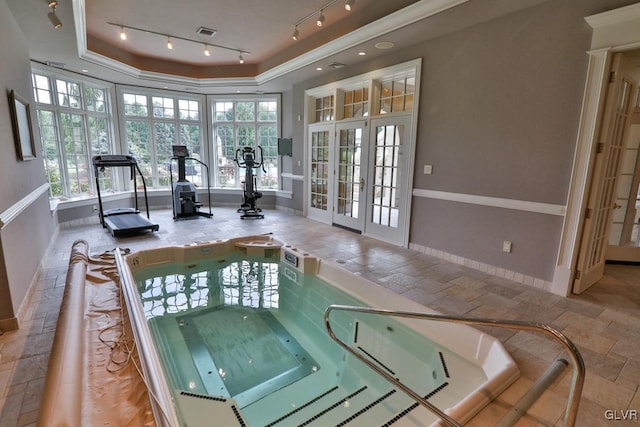 view of swimming pool with an indoor hot tub