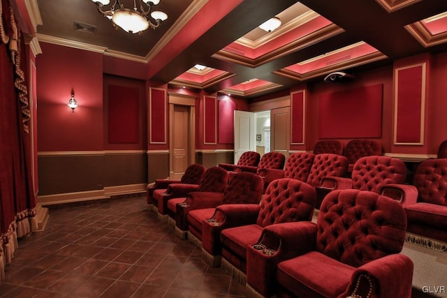 tiled home theater featuring beamed ceiling, a notable chandelier, ornamental molding, and coffered ceiling